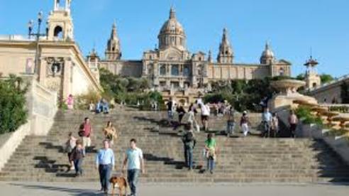 People walking down steps toward the National Art Museum in Barcelona.