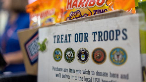 "Treat Our Troops" donation box with Haribo candy packs, supporting USO and military service members.